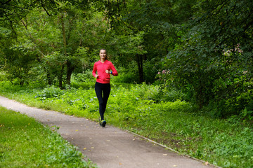 Young slim woman jogging in a park