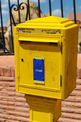 yellow mailbox with lettering 