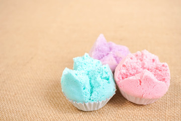 Muffins, Thai Muffins or Thai rice flour muffins. Homemade muffins in pink, purple and blue color on the wooden board. Soft focus on the front of blue muffin. Copy space