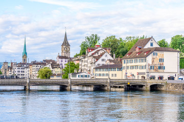 Beautiful view of historic city center of Zurich with river Limmat on a sunny day with blue sky and clouds in summer, Canton of Zurich, Switzerland.