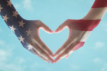 American flag pattern on human hands in heart sign shape, text message honor all who served for brave military on blue background