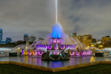 Chicago skyline panorama with skyscrapers and Buckingham fountain in Grant Park at night lit by...