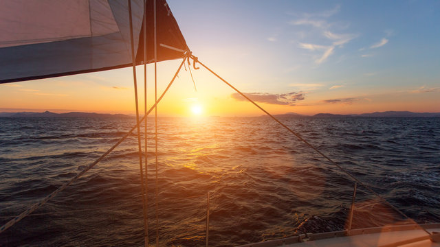 Fototapeta Stunning sunset with sailing yachts in the Sea.