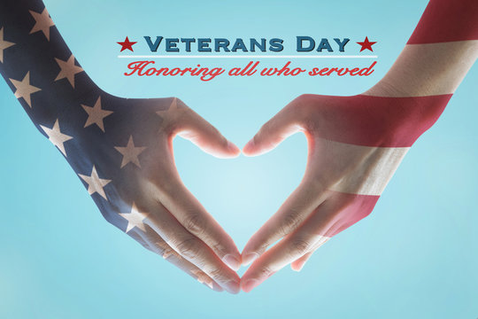 Veterans day holiday celebration concept: American flag pattern on human hands in heart sign shape, text message honor all who served for brave military on blue background