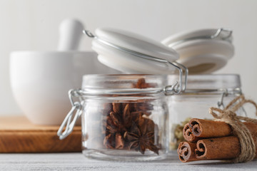 Spices on black background in special jars. Food