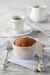 Cupcakes and cup of coffee on wooden table