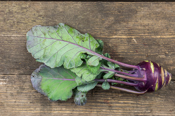 Red Kohlrabi on a rusctic wooden  background.