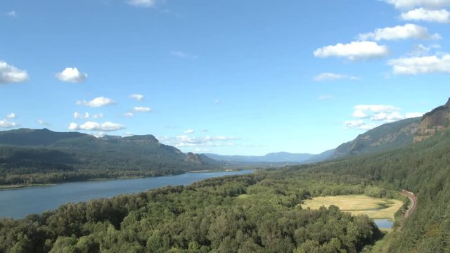 Establishing shot of the Columbia River Gorge, Oregon and Washington at high elevation on beautiful blue sky day.