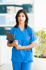 Young Woman Hispanic Doctor Nurse in Medical Office