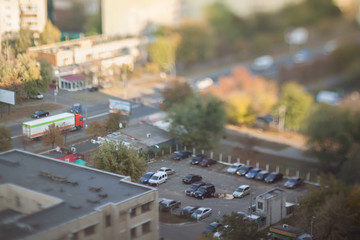 Parking near the highway. Blurry tilt-shift cityscape. 