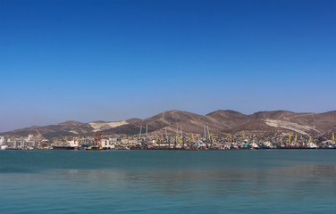 Sea port with mountain landscape, blue sky