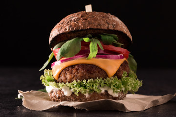 Tasty grilled burger with lettuce and mayonnaise ,on blackboard table