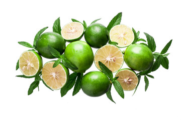 Lime background. Fresh limes with slices and mint leaves around.