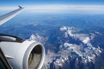Fototapeta na wymiar AUSTRIA - October 2016: The alps as seen from an airplane, wing view with plane turbine or engine