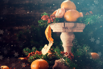 Christmas composition with tangerines and falling snow flakes. Christmas Card.