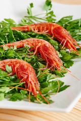 Raw prawns and parsley on white dish
