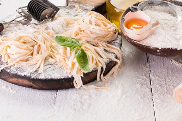 Still life with raw homemade pasta and ingredients for pasta