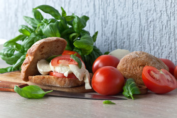 Sandwich with mozzarella, tomato and basil