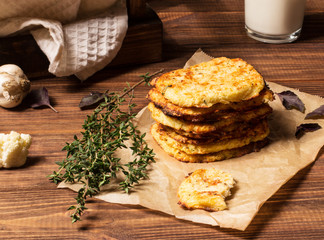 Hash browns cauliflower on a brown wooden background, selective focus, horizontal