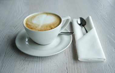 Cup of coffee on top of the white wooden table