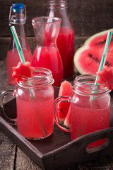 Watermelon drink in glasses with slices of watermelon mint and lemon,