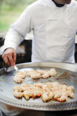 Shrimp scampi grilled on tepan grill, wrapped in noodles, chef