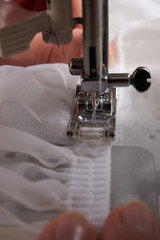 Young woman sewing fabric