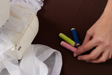 Young woman sewing fabric