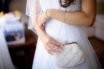 wedding satin beautiful handbag in bride's hand