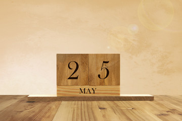 Cube shape calendar for May 25 on wooden surface with empty space for text.