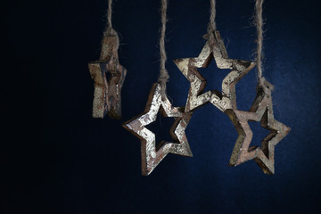 Christmas garland of wooden stars on a dark blue background.