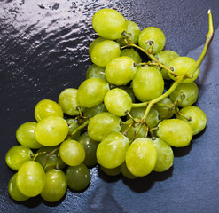 Bunch of grapes on a black slate stone