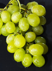 Bunch of grapes on a black slate stone