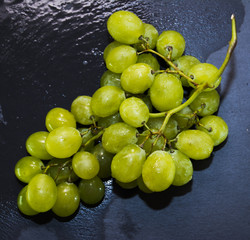 Bunch of grapes on a black slate stone