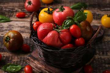 Fototapeta na wymiar Colorful tomatoes, red tomatoes, yellow tomatoes, orange tomatoes, green tomatoes. Tomatoes background. vintage wooden background