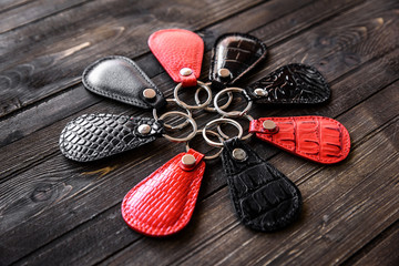 Keys attached to leather keychain , on wooden background