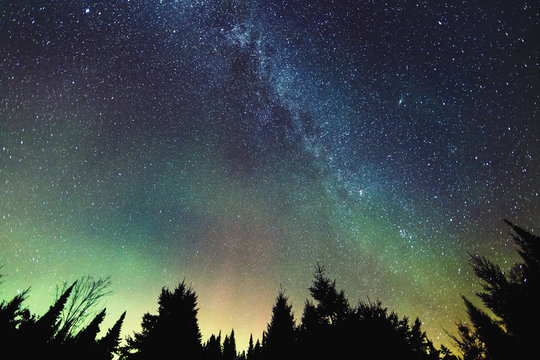 Aurora Borealis and milky way visible in the sky, Mont-Tremblant National Park; Lanaudiere region, Quebec, Canada