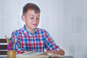 Funny boy reading a book