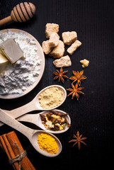 Ingredients for ginger biscuits, Christmas baking, and baking to the day of Thanksgiving: ginger, cinnamon, cardamom, citrus peel, anise. Top view, copy space