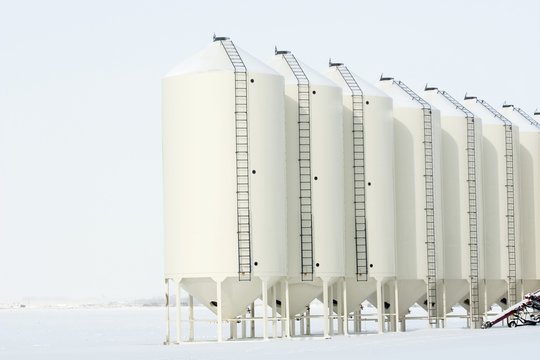 White Metal Grain Bins In The Winter