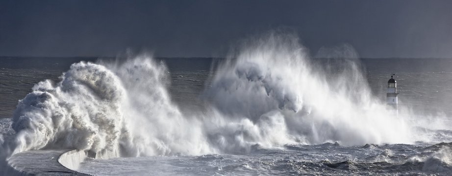 Waves crashing on lighthouse, Seaham, Teesside, England, UK