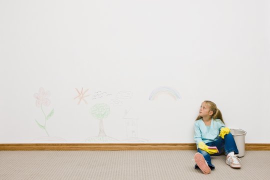 Girl Cleaning Drawing On The Wall
