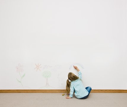 Child Drawing On The Wall