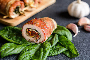 Pork cutlets wrapped in bacon and stuffed with cheese, spinach and sun dried tomato