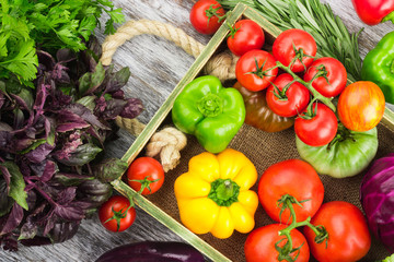 Set of raw vegetables in the wooden tray