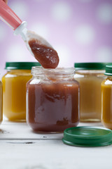 Healthy ready-made baby food on a wooden table
