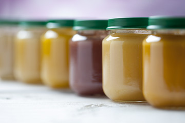 Healthy ready-made baby food on a wooden table