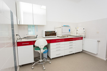 Workplace in dentistry. Table with a packaging machine, ultraviolet shelf, sterilizer, autoclaving. Sterilization room