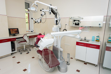 Modern dental office with professional digital microscope equipment and view from the microscope displayed on the screen computer. Dentistry