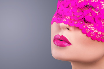 Fototapeta premium Woman with a pink blindfold on her face